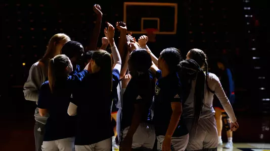 women's basketball team huddle