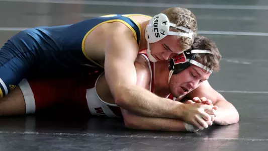 Rocky Jordan controls his Wisconsin opponent on the mat in a season-opening win.