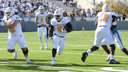 Ailym Ford runs through a huge hole created by Malone VanGorder on the left and McClendon Curtis on the right.