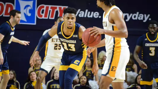 Malachi Smith guards the ball at ETSU.