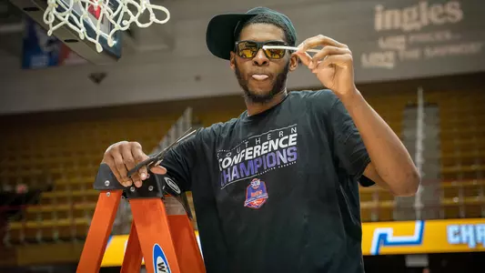 Darius Banks cuts down the nets at the SoCon Tournament