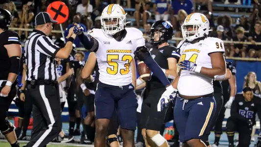 Ben Brewton points at sidelines in celebration at EIU
