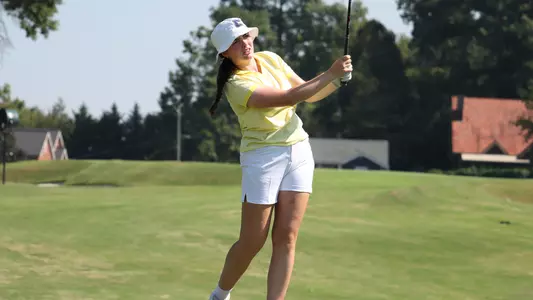 Megan Docherty follows her tee shot to the green on a par 3.