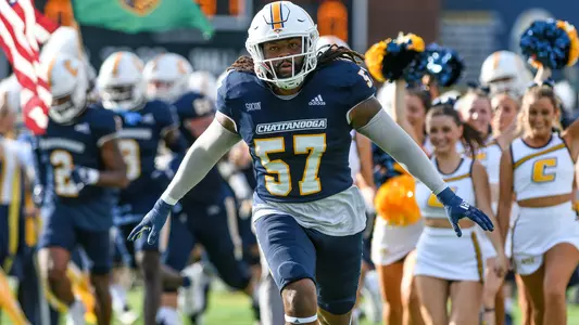 Kam Jones leads the team onto the field in the season opening win over Wofford.