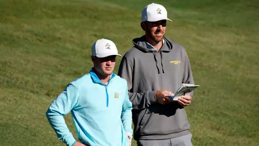 Coach Blaine Woodruff counsels a player on his next shot