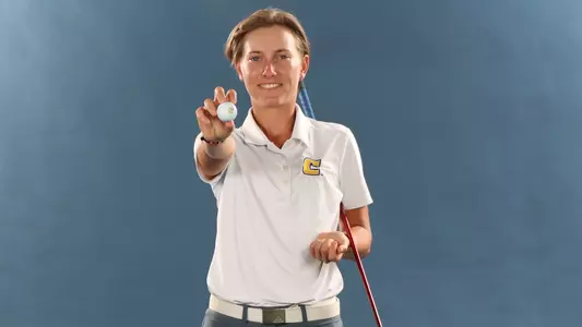 Dorota Zalewska poses on media day showing the Power C logo on a golf ball