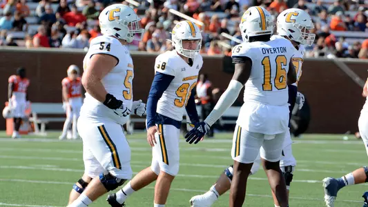 Clayton Crile is congratulated after 1 of his school-record 5 field goals in the win at Mercer