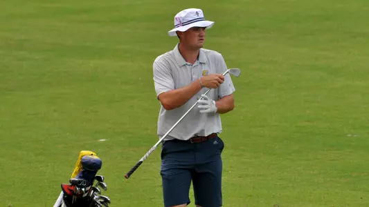 Paul Conroy visualizes his next shot as he pulls an iron out of his bag at the NCAA Auburn Regionals.