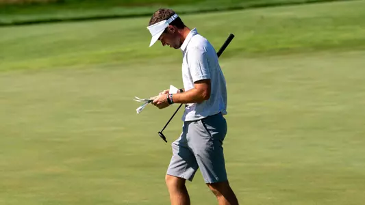 Samuel Espinosa studies his notes prior to a putt at Erin Hills.