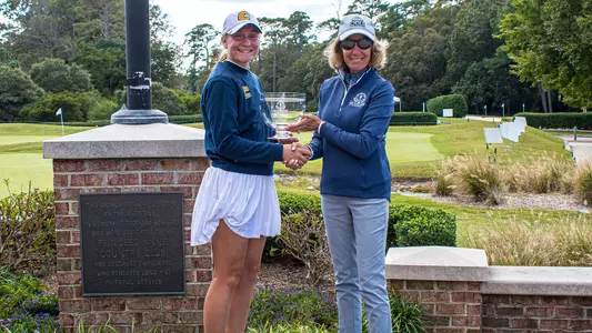 Makenzie Cooper is presented the medalist trophy for her win at the Evie Odom Invitational