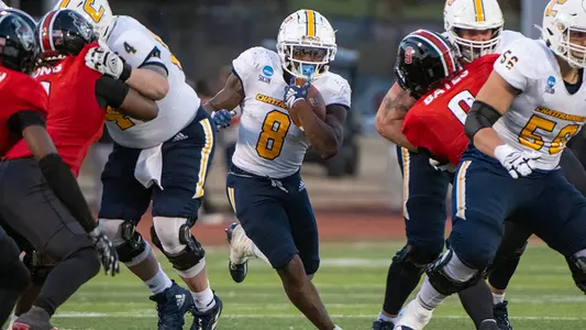 Gino Appleberry bursts through a large hole in the win at Austin Peay