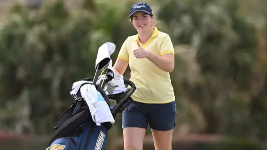 Megan Docherty gives a thumbs up during her trek between shots at Tulane