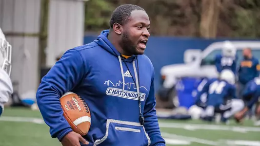 Coach D.J. Knox provides instructions to his running backs during spring practice
