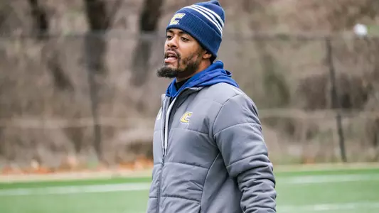 Korel Smith provides instruction to his secondary during spring drills