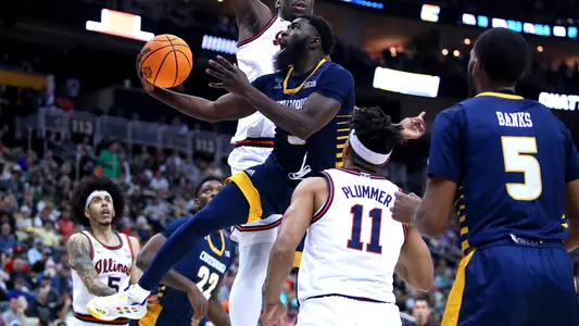 David Jean-Baptiste flies through traffic to complete a reverse layup in the NCAA Tournament against Illinois