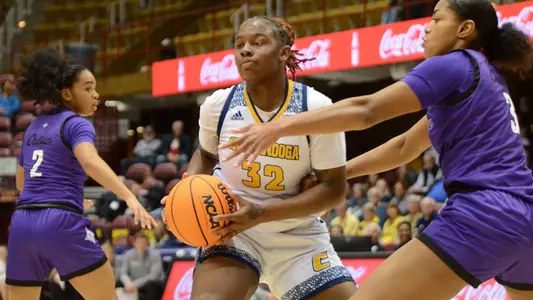 Raven Thompson looks to dish from the paint against Furman