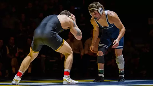 Matthew Waddell sizes up his Iowa opponent early in the dual