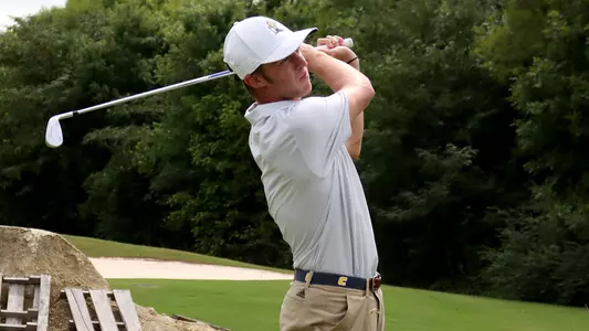 Garrett Engle follows through on his irons at practice