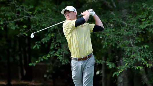 John Houk finishes his tee shot on the par 3 5th hole at the Oconee Course