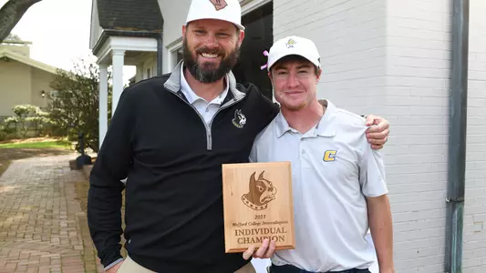 John Houk poses with Wofford Coach with winning medalist trophy at Wofford Intercollegiate