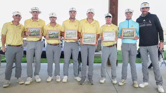 Team photo with trophy from Hoosier Collegiate Invite. PHOTO CUTLINE (L-R): Asst. Coach Nick Robinson, Paul Conroy, Braedon Wear, Samuel Espinosa, Carson Johnson, John Houk, Garrett Engle & Coach Blaine Woodruff.