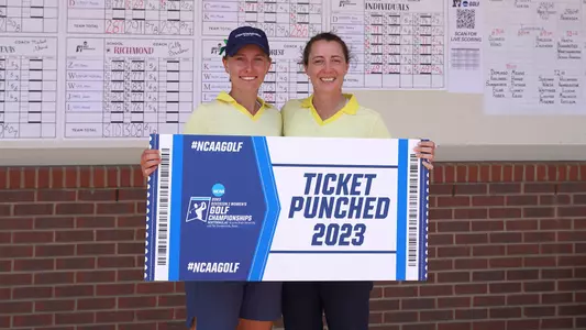 Dorota Zalewska & Coach Colette Murray hold up their ticket punched sign for advancing to NCAA Finals
