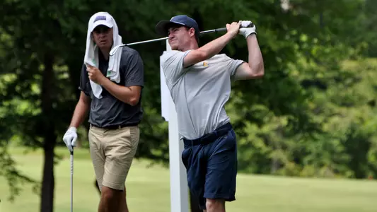 John Houk completes his swing on the par 3 8th at Auburn University Club