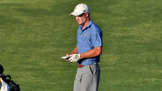 John Houk takes a look at his yardage book plotting his next shot at the NCAA Championships
