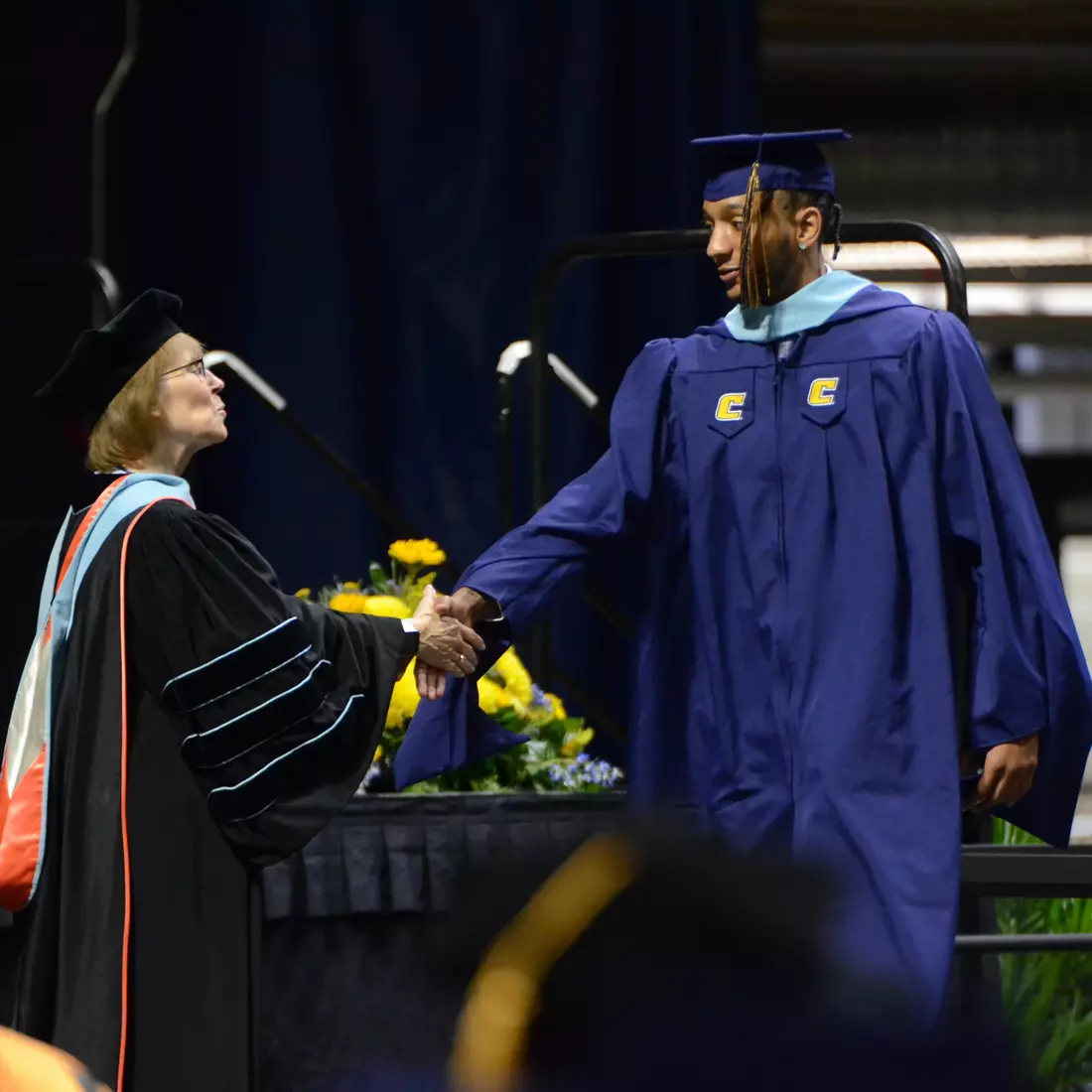 Men's basketball standout Jamal Johnson with UTC FAR Dr. Valeria Rutledge as he earns his Master's Degree in Education.