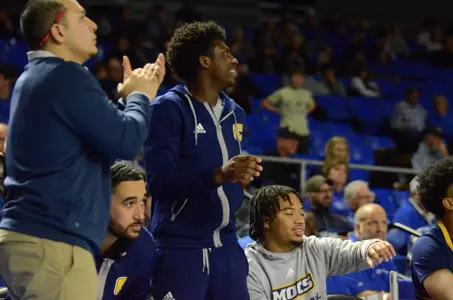 Honor Huff cheering teammates on versus Belmont
