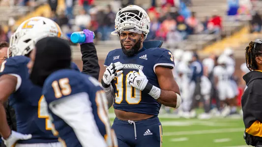 Jay Person points to himself on the sidelines at Finley Stadiun