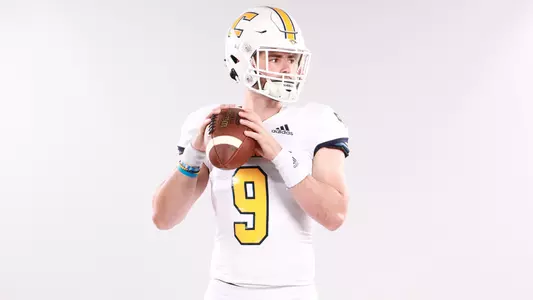 Chase Artopoeus poses in passing form for video board & graphics content