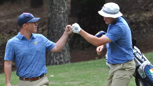 Paul Conroy & Asst. Coach Nick Robinson fist bump after a good shot at the 2023 SoCon Championships.