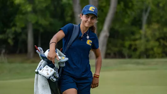 Violeta Fernandez with an impish smile walking with her bag over her shoulder at Vandy