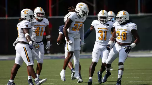 Telly Plummer celebrates his open field tackle stopping Samford on 4th down with his teammates