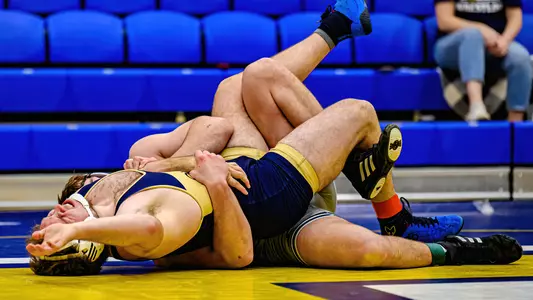 David Harper rolls his Queens opponent onto his back building a tech fall win