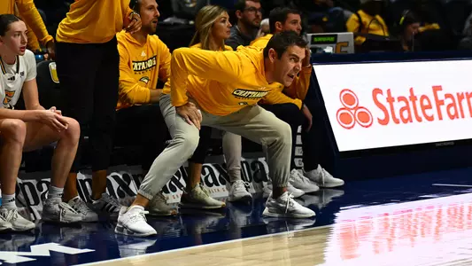 Coach Shawn Poppie in an aggressive, defensive posture as one of the most animated coaches in the game.
