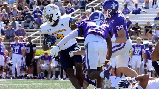 Reggie Davis busts through Furman defenders in the Mocs 2024 romp in Greenville