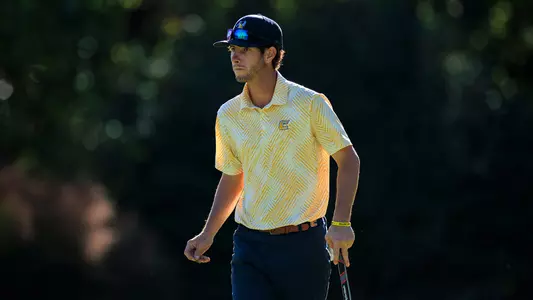 Braedon Wear surveys the green as he walks his line on the green at Kentucky