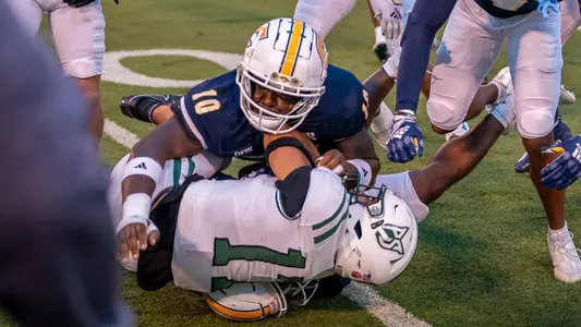 Joseph Bakhole completes a punishing tackle at the sideline in the win over Portland State