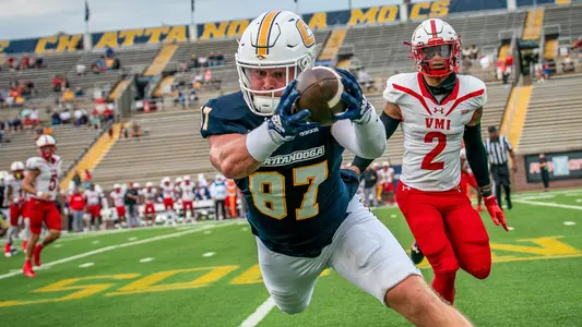 Jay Gibson gets he feet in as he stretches to make a catch at the sidelines in the win over VMI