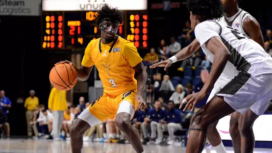 Honor Huff looks for an opening in the lane dribbling against Bryant