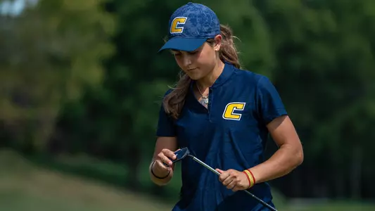 Violeta Fernandez-Tagle checks out her putter face as she awaits her turn on the green at Vandy