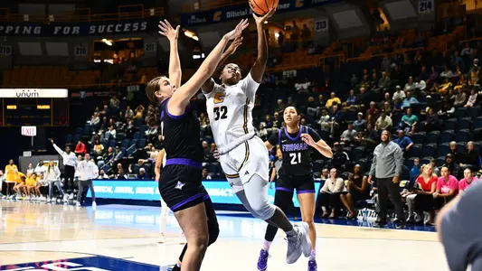 Raven Thompson drives hard to the basket finishing with her left hand at the basket
