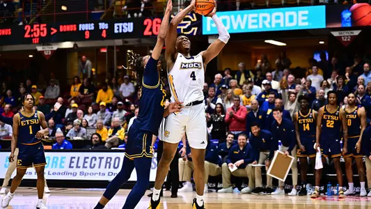 Sam Alexis fights through contact to score in the 1st half against ETSU