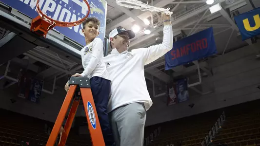 Coach Shawn Poppie & son Kai celebrate with the net atop the ladder after winning the 2024 SoCon Championship