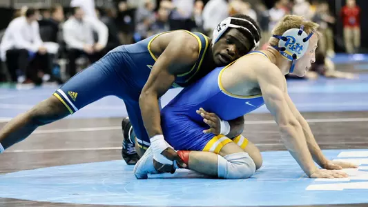 Isaiah Powe starts on top as he & Pitt's Cole Matthews await the referees whistle at the NCAA Championships