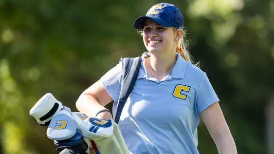 Kera Healey is all smiles carrying her bag as she approaches the green for a birdie putt at ODU.