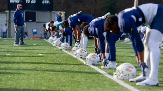 Team stretch prior to practice under watchful eye of Coach Gerry Pacitti