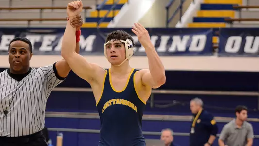 Sergio Desiante pumps up the crowd with his hand raised after his win over App State